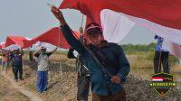 Di Jembatan PIK Dilarang, Di Bekasi Warga Bentangkan Bendera Merah Putih Raksasa di Lahan Tambak